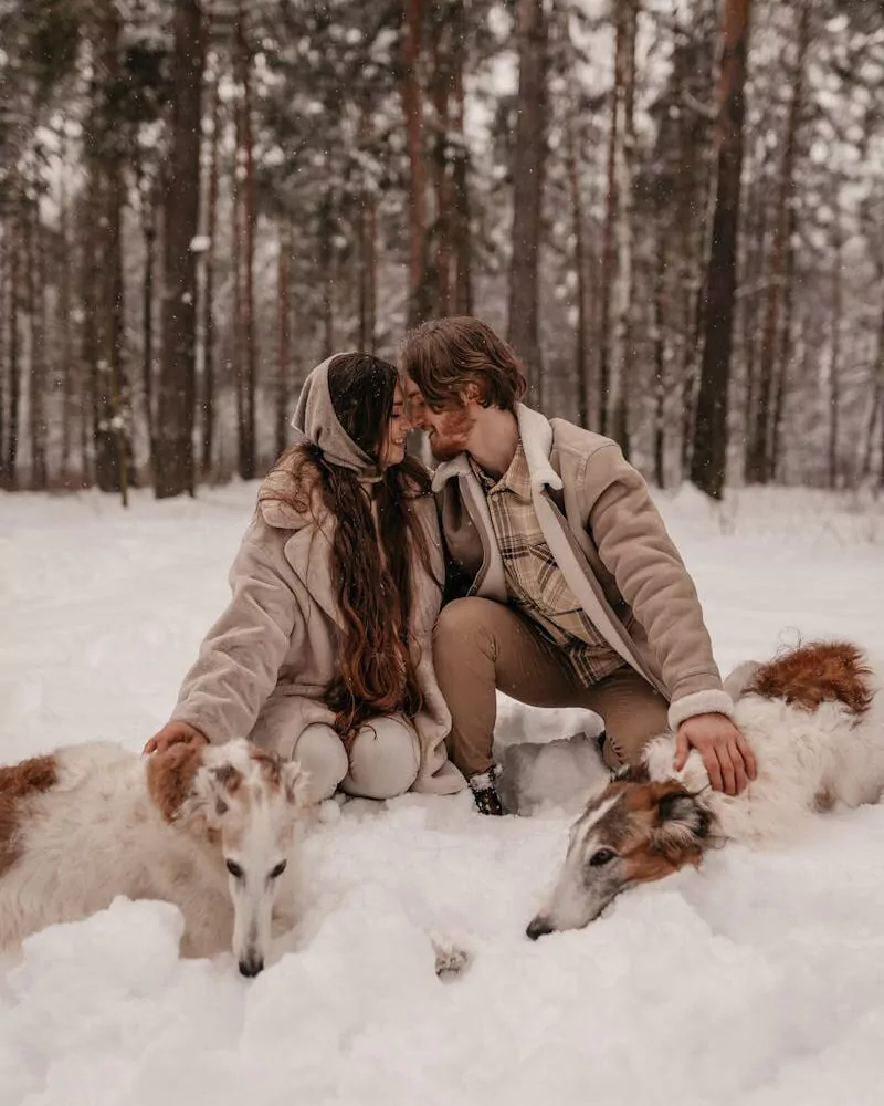 A Romantic Couple with Their Pets in the Snow